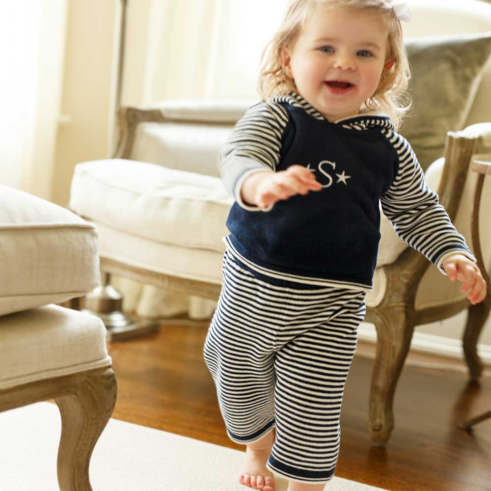 Check out one of our new arrivals! Your little one will be cuter than cute in this striped hoodie/pant set! Lightweight and versatile fabric and featuring a convenient zipper back. Front of hoodie is also great for adding personalized text and/or images!  100% Cotton by a soft idea